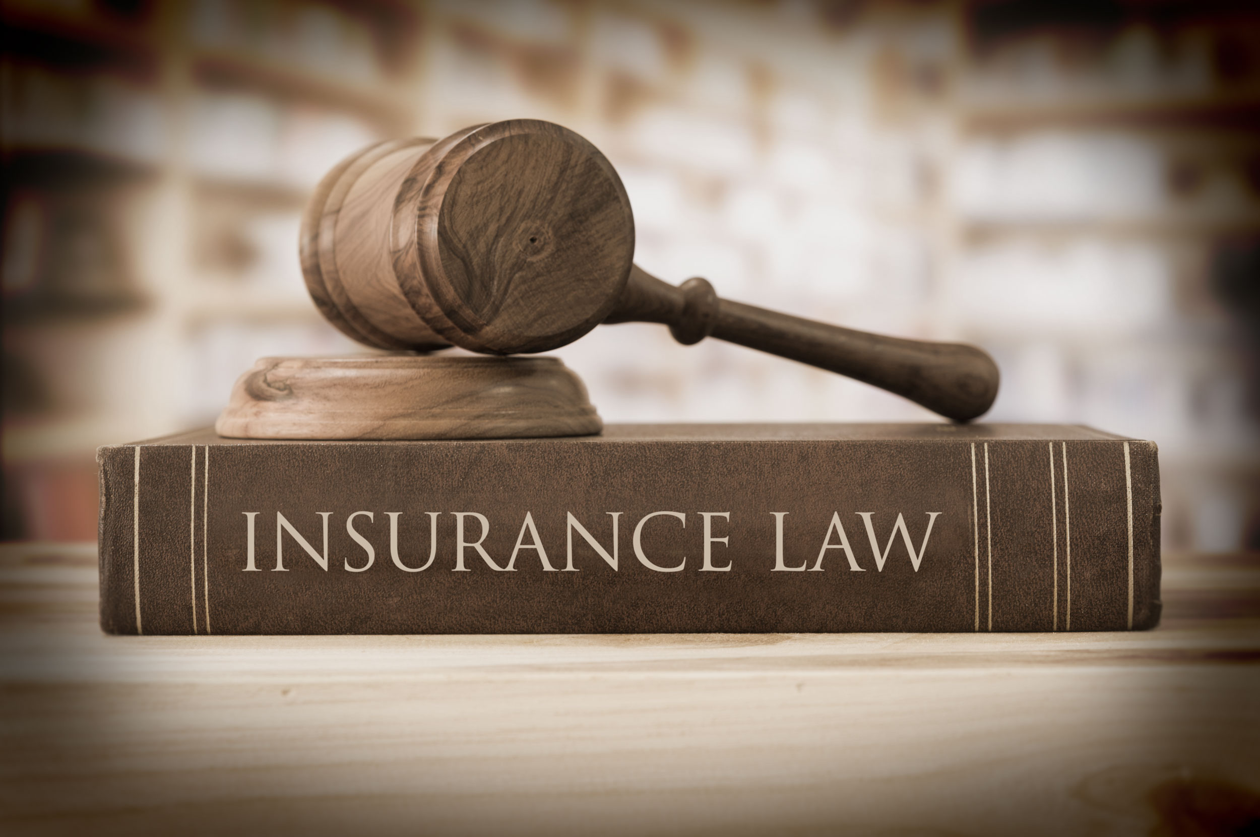 Insurance Law books and gavel